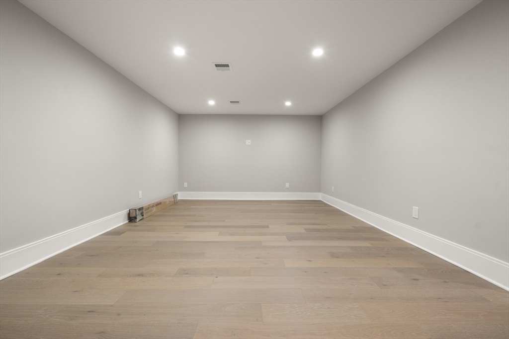 2 Rockwood Road Natick, MA 01760 - Photo 31 of 37 an empty room with wooden floor and windows