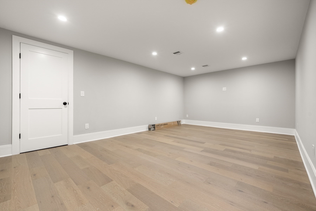 2 Rockwood Road Natick, MA 01760 - Photo 32 of 37 an empty room with wooden floor and windows