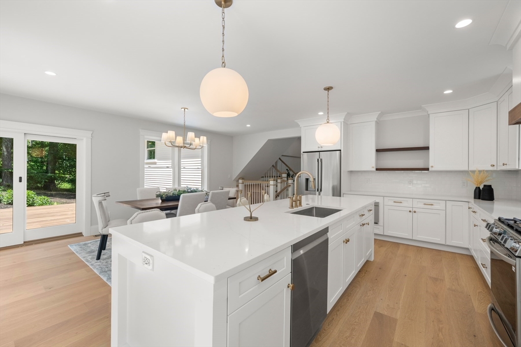 2 Rockwood Road Natick, MA 01760 - Photo 4 of 37 a kitchen with sink stove and white cabinets with wooden floor