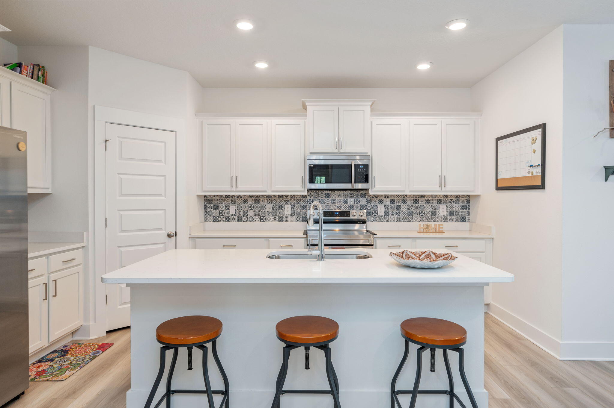 165 Blooming Cove Crestview, FL 32539 - Photo 11 of 44 a kitchen with stainless steel appliances a dining table chairs and a refrigerator