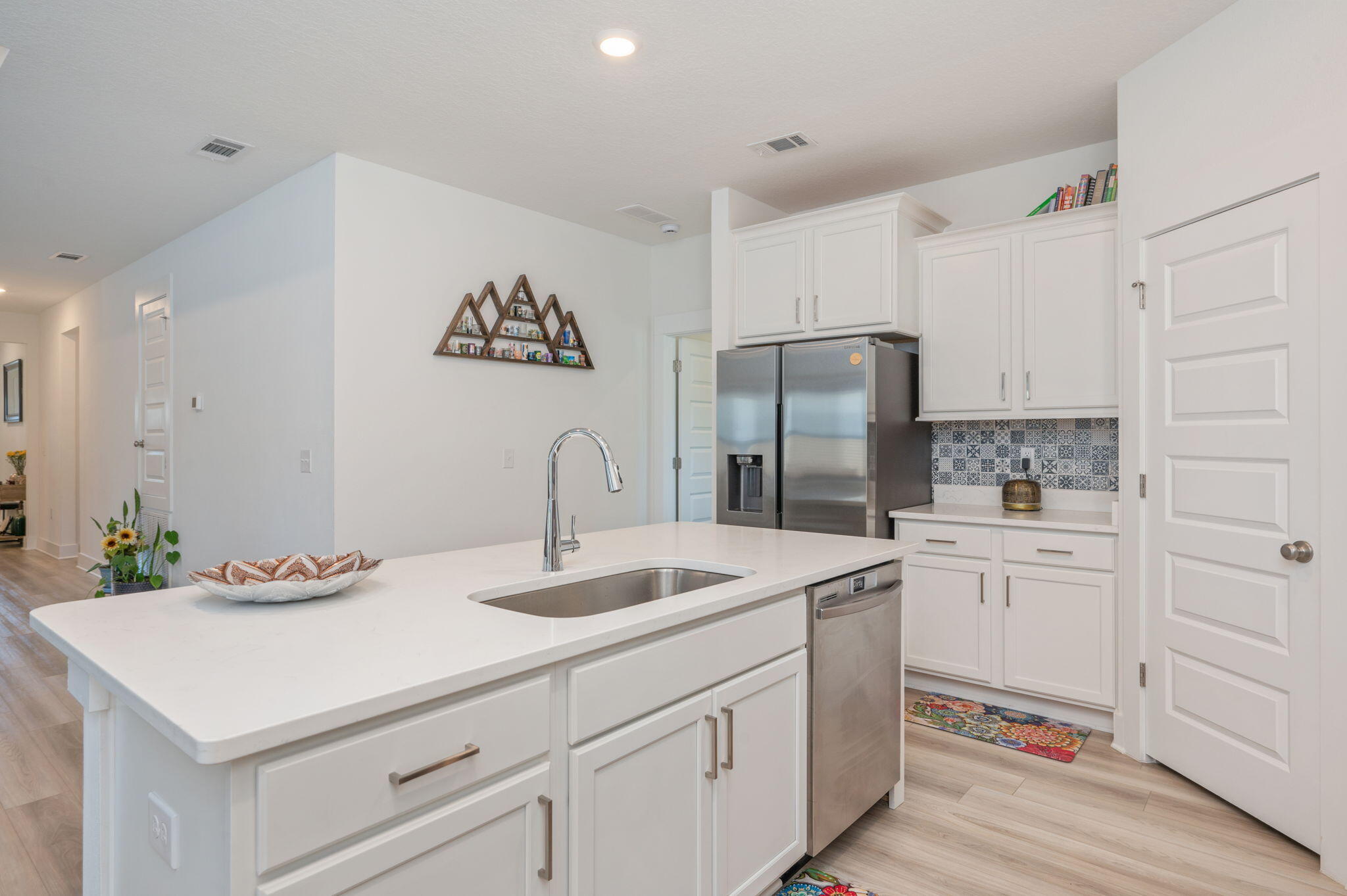165 Blooming Cove Crestview, FL 32539 - Photo 13 of 44 a kitchen that has a lot of white cabinets and stainless steel appliances