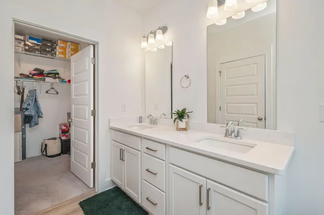a bathroom with a sink double vanity and a mirror