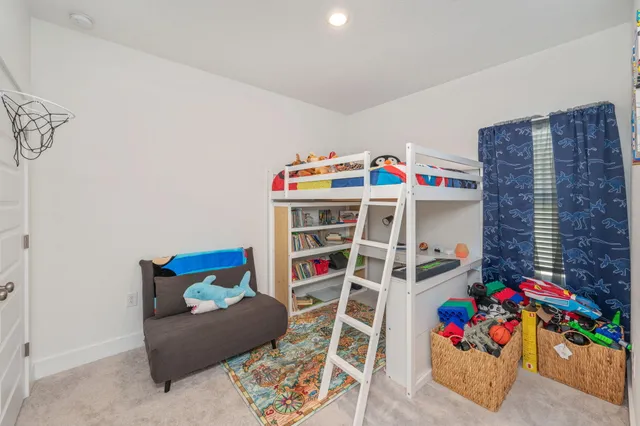 a bedroom with a bed and a book shelf