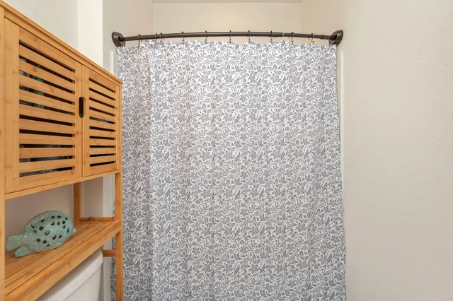a bathroom with a shower curtain and a curtain