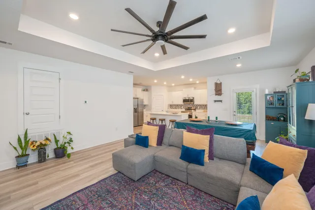 a living room with furniture and kitchen view