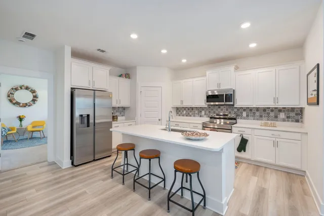 a kitchen with stainless steel appliances a refrigerator stove microwave and cabinets