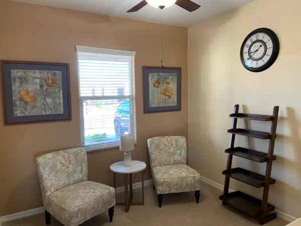 a living room with furniture a clock and a window
