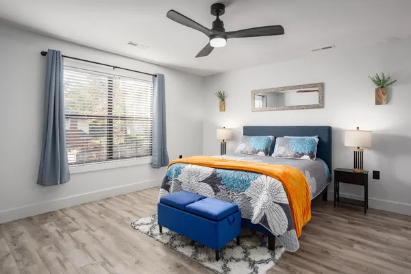 a bedroom with a bed couch and window