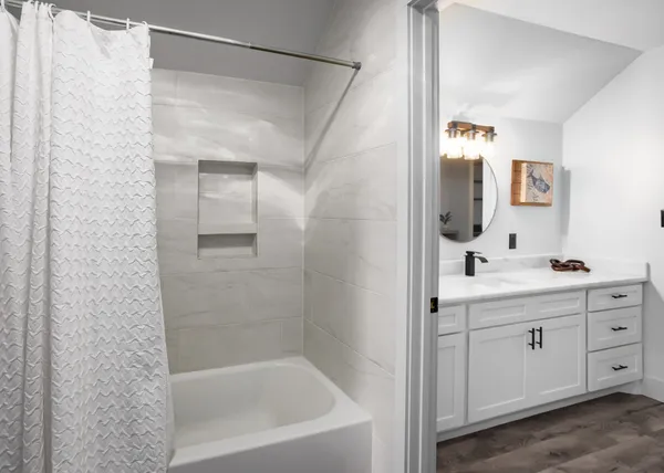 a bathroom with a bathtub and a sink