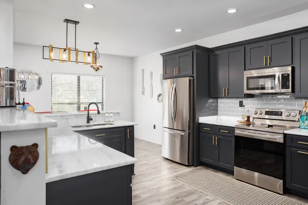 a kitchen with refrigerator cabinets and microwave