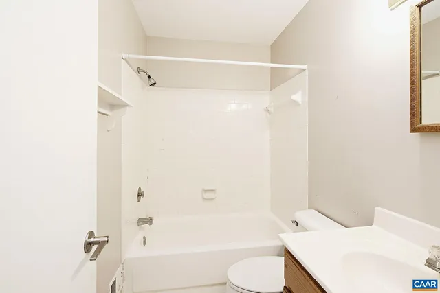 a bathroom with a toilet and a bathtub