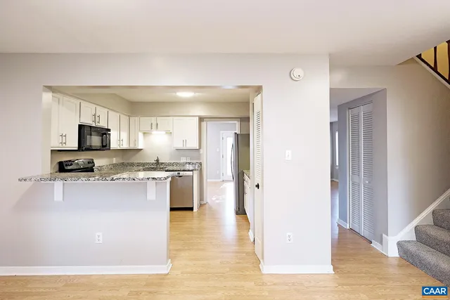 a view of kitchen with stainless steel appliances cabinets