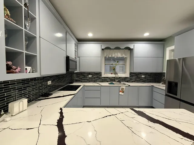 a kitchen with stainless steel appliances kitchen island granite countertop a sink and cabinets