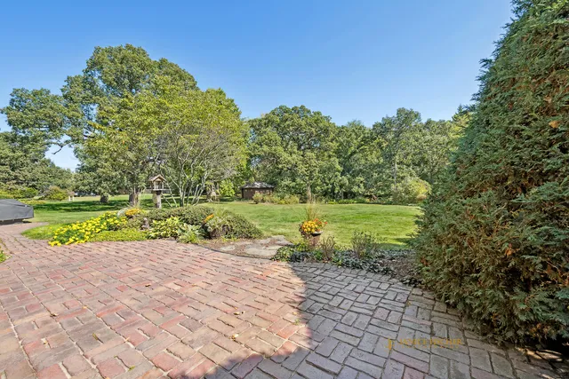 a view of house with yard and car parked