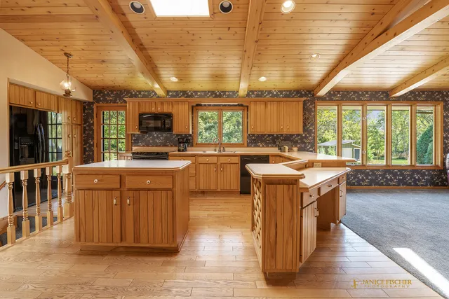 a kitchen with stainless steel appliances granite countertop a stove a sink dishwasher and a refrigerator