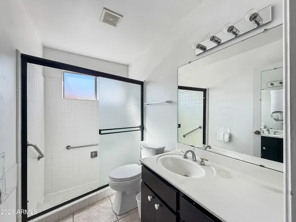 a bathroom with a sink toilet and mirror