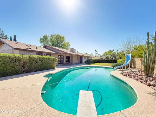 a view of a swimming pool with a patio