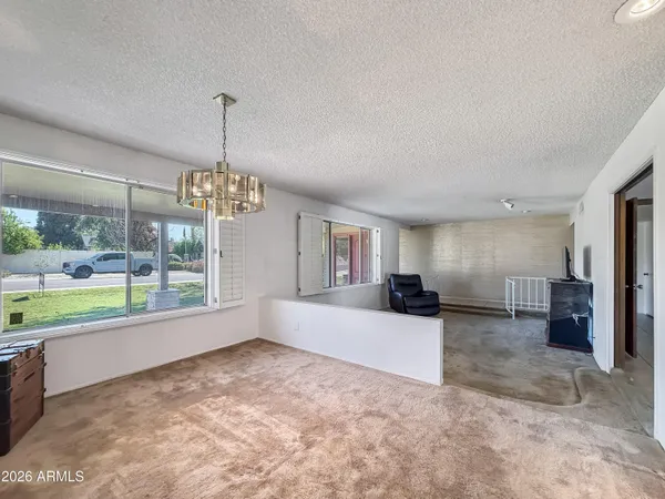 a view of a livingroom with a kitchen and microwave