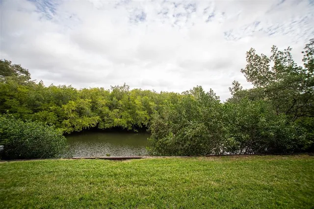 a view of a green field with wooden fence