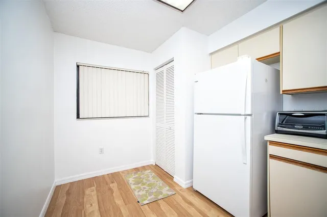a view of a kitchen with wooden floor