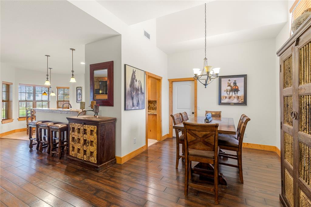 777 Stiles Road Whitesboro, TX 76273 - Photo 13 of 37 a view of a dining room with furniture window and wooden floor