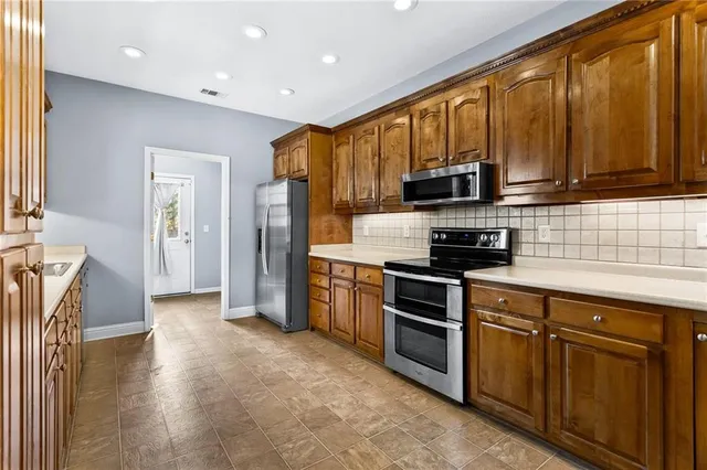 a spacious bathroom with a granite countertop sink mirror and a bathtub