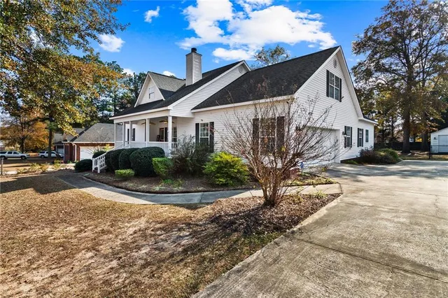 a view of a white house with a yard