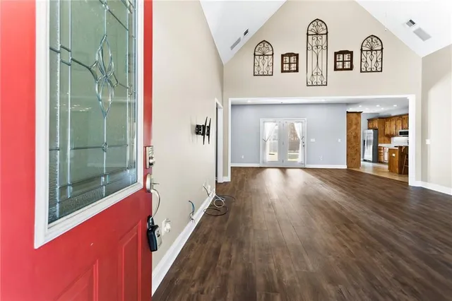 a view of an empty room with wooden floor