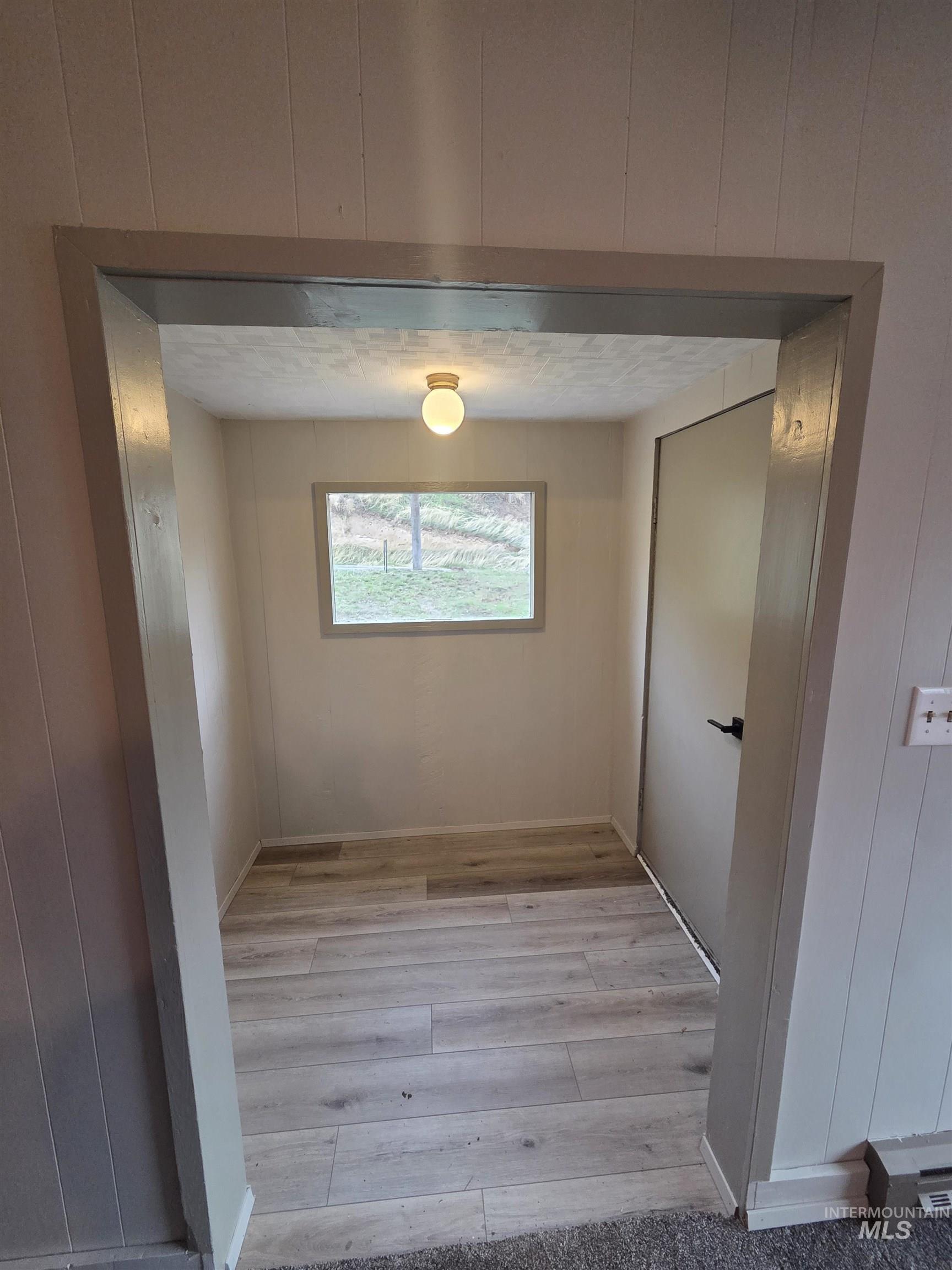 465 South 15th Street Pomeroy, WA 99347 - Photo 16 of 24 Corridor featuring light wood finished floors and wood walls