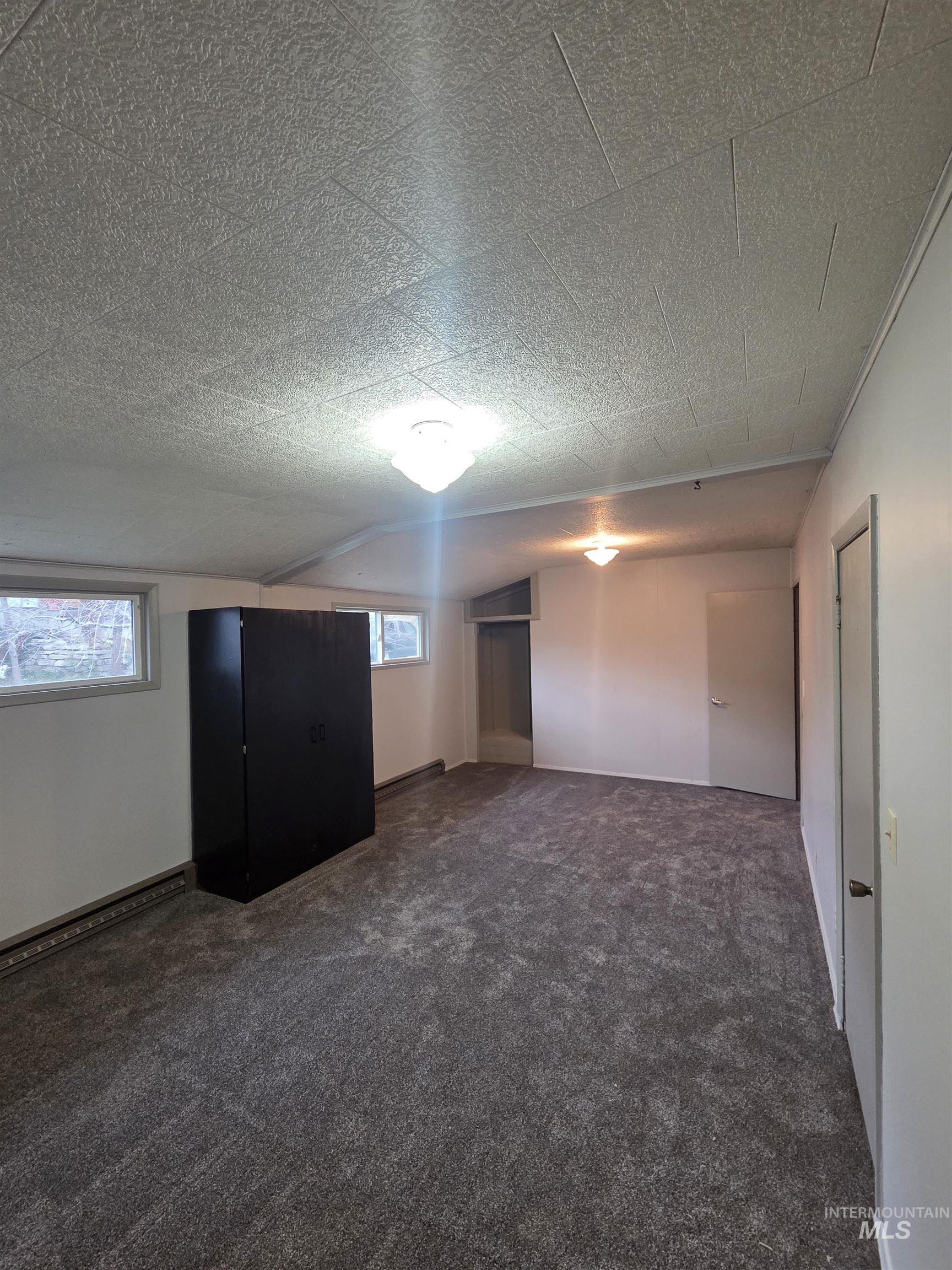 465 South 15th Street Pomeroy, WA 99347 - Photo 17 of 24 Bonus room with dark carpet and a textured ceiling