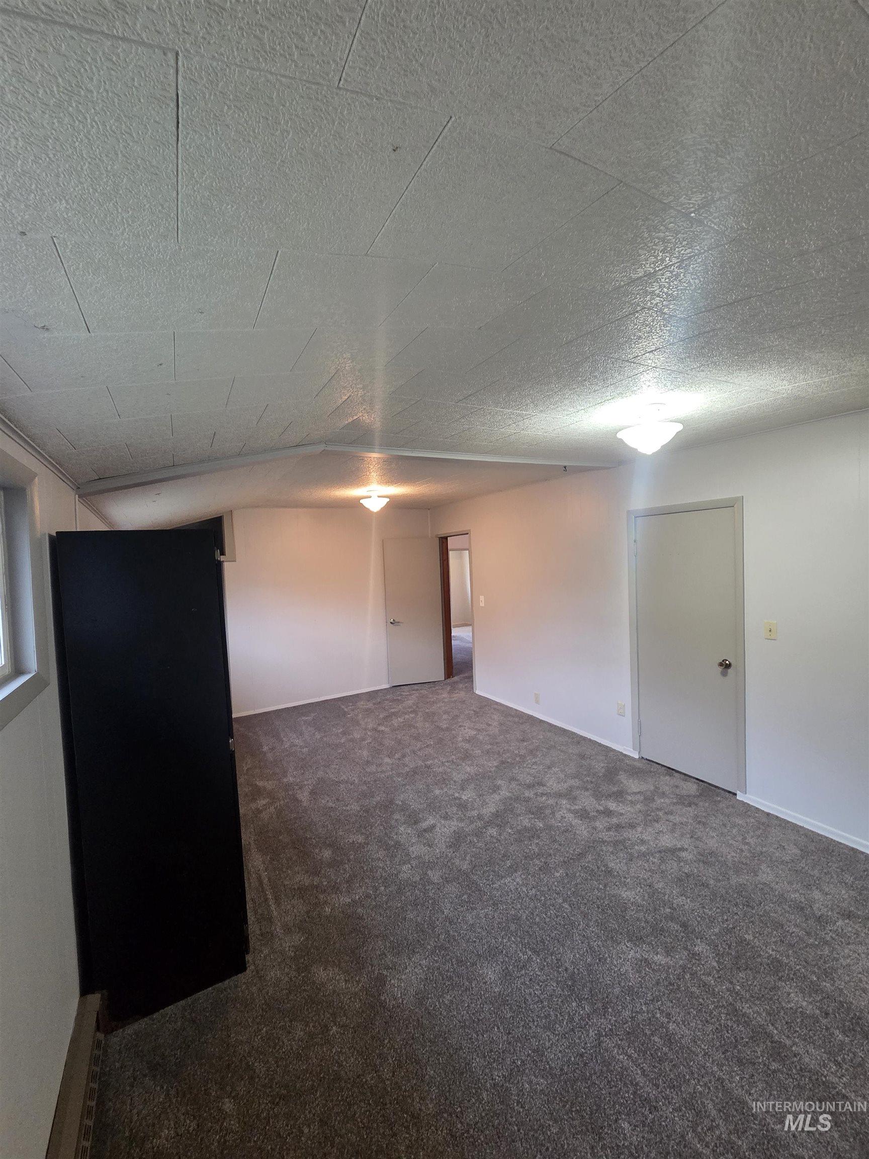 465 South 15th Street Pomeroy, WA 99347 - Photo 18 of 24 Empty room with dark carpet and a textured ceiling