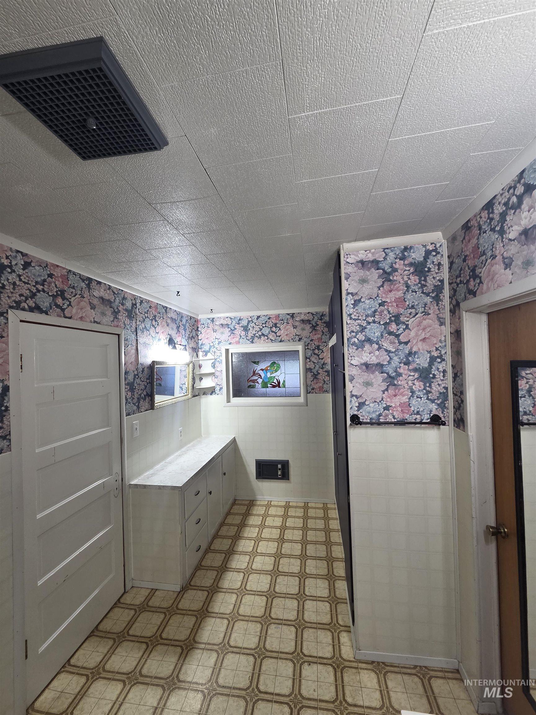 465 South 15th Street Pomeroy, WA 99347 - Photo 20 of 24 Bathroom featuring wallpapered walls, wainscoting, light flooring, and vanity