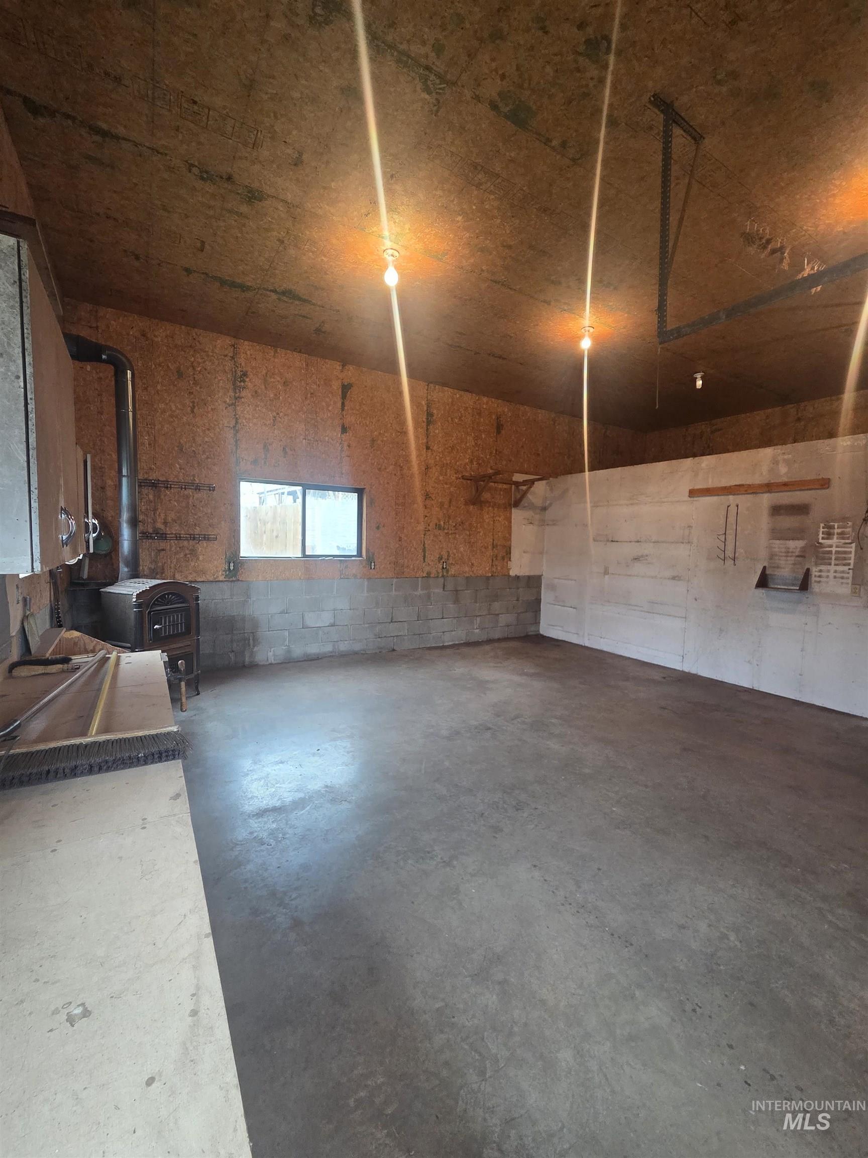 465 South 15th Street Pomeroy, WA 99347 - Photo 4 of 24 Miscellaneous room featuring a wood stove and concrete flooring