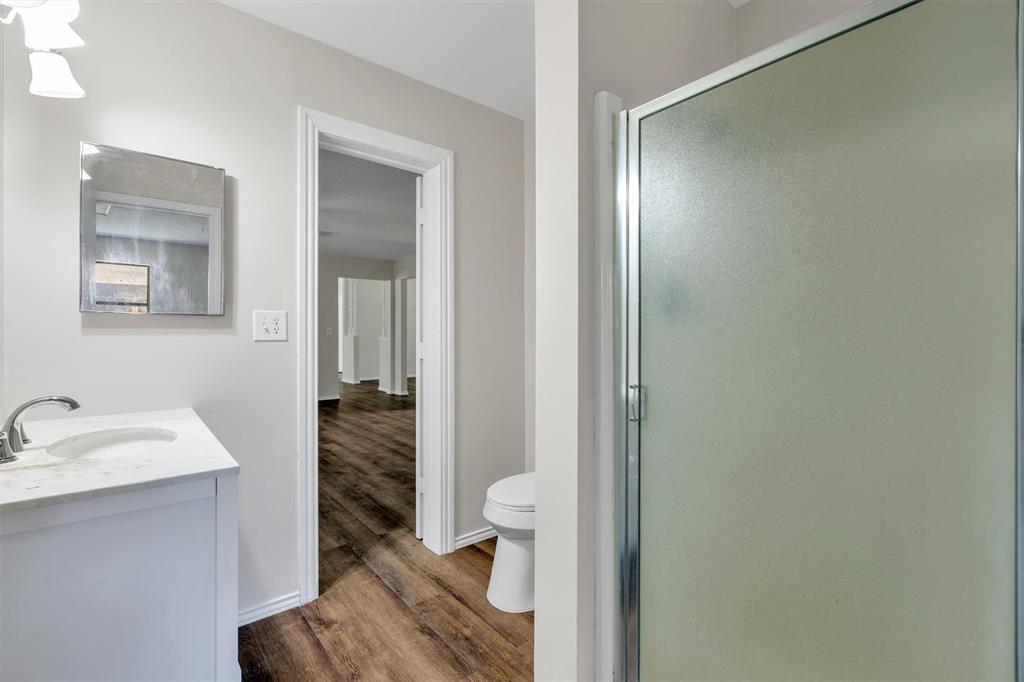 209 Mistletoe Lane Keene, TX 76059 - Photo 26 of 38 a bathroom with a sink and a mirror