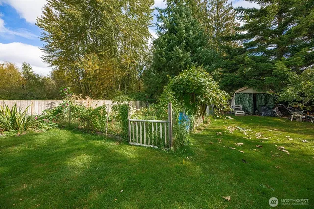 a view of a house with backyard and sitting area