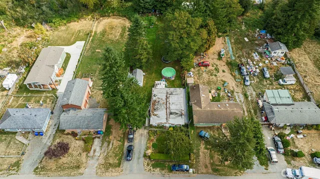 an aerial view of a house with yard swimming pool and outdoor seating