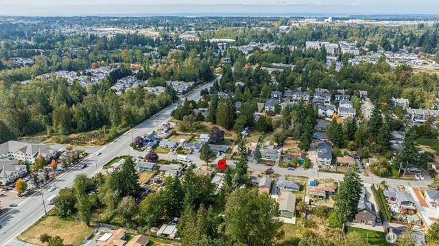 an aerial view of residential houses with outdoor space and swimming pool