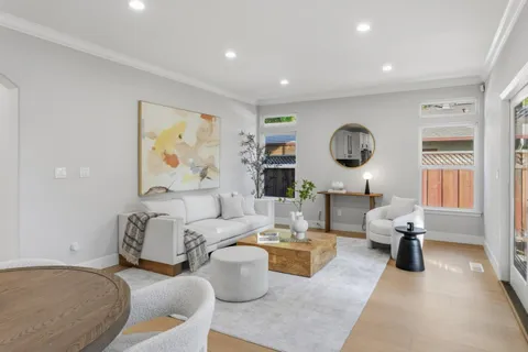 a living room with furniture and painting on the wall