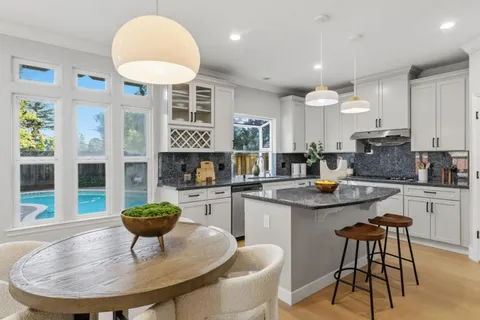 a kitchen with a dining table and chairs