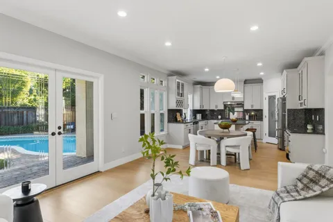 a view of a kitchen with dining room and wooden floor