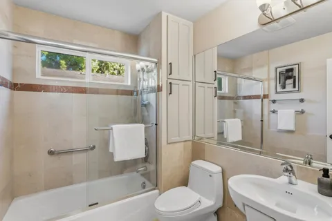 a bathroom with a toilet sink and shower