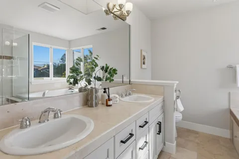 a bathroom with a double vanity sink and a mirror