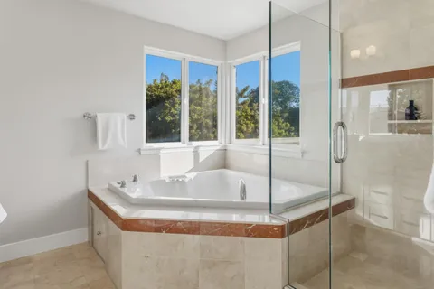 a bathroom with a granite countertop sink and mirror