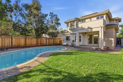 a view of a house with a backyard