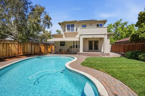 a view of a house with a backyard and a patio