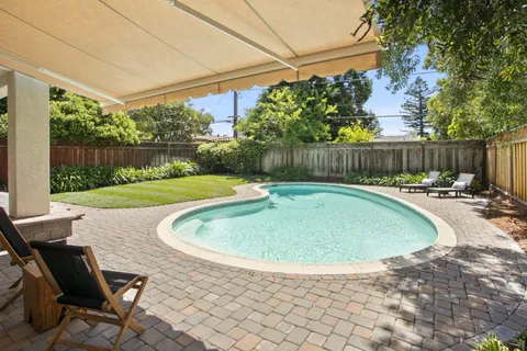 a view of a swimming pool with a patio