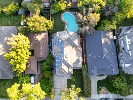 an aerial view of a house with a lot of flower plants
