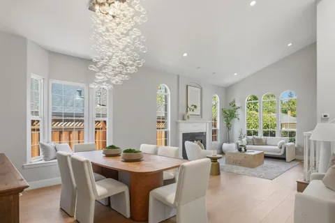 a living room with fireplace furniture and a large window