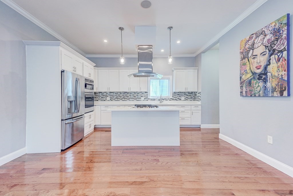 1008-1010 River Street, Unit 1 Boston, MA 02136 - Photo 12 of 29 a large kitchen with stainless steel appliances granite countertop a stove a sink dishwasher a refrigerator white cabinets and wooden floor