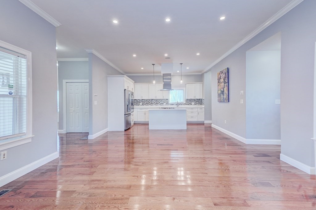 1008-1010 River Street, Unit 1 Boston, MA 02136 - Photo 15 of 29 a view of kitchen with kitchen island sink refrigerator and white cabinets